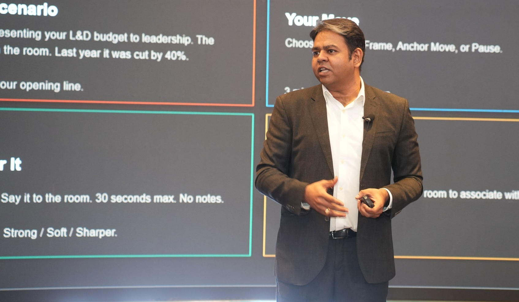 Sharat Sharma leading a learning and development session on stage